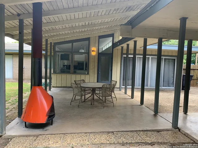an outdoor sitting area with furniture