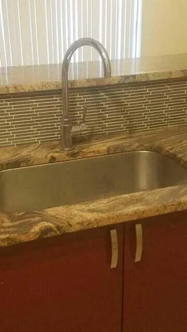 a view of a livingroom with an empty space and a window