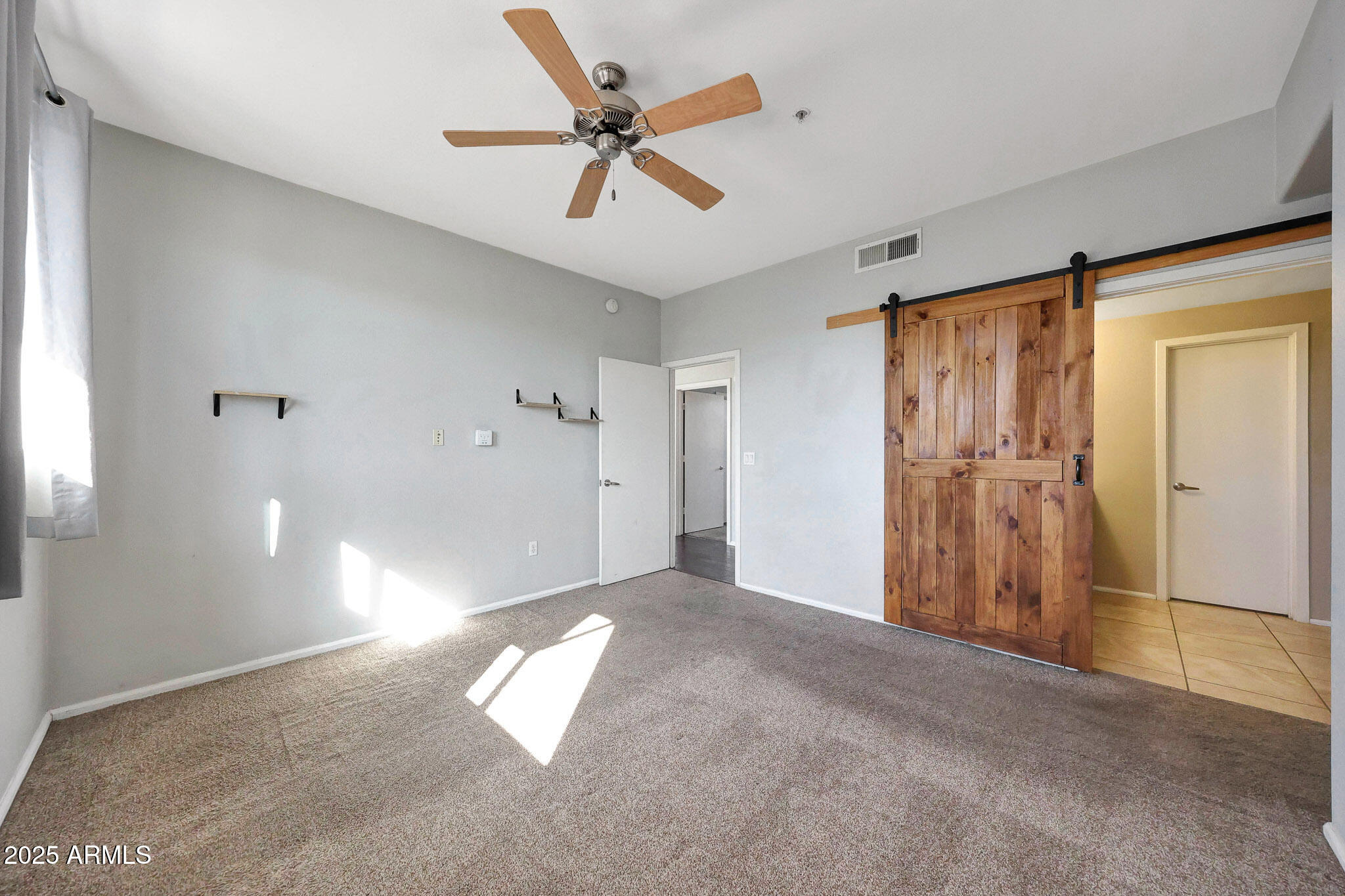 6605 North 93RD Avenue, Unit 1067 Glendale, AZ 85305 - Photo 13 of 47 a view of empty room with ceiling fan