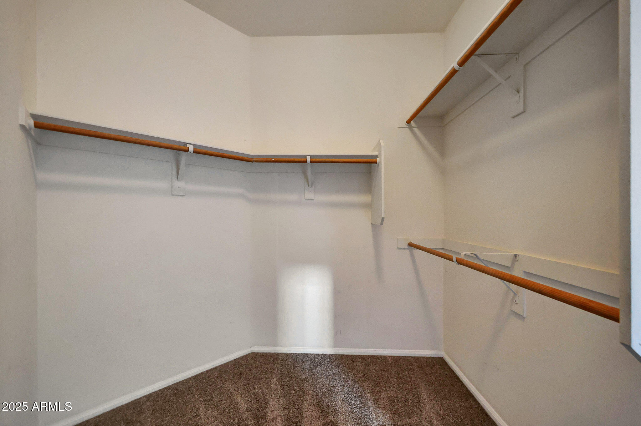 6605 North 93RD Avenue, Unit 1067 Glendale, AZ 85305 - Photo 18 of 47 a view of walk in closet with empty racks