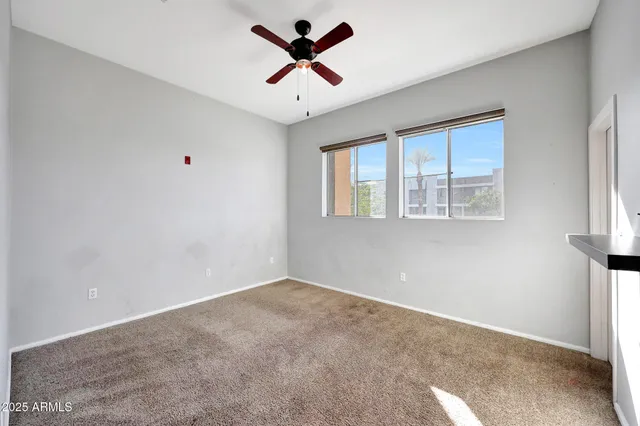 a view of a room with window and ceiling fan