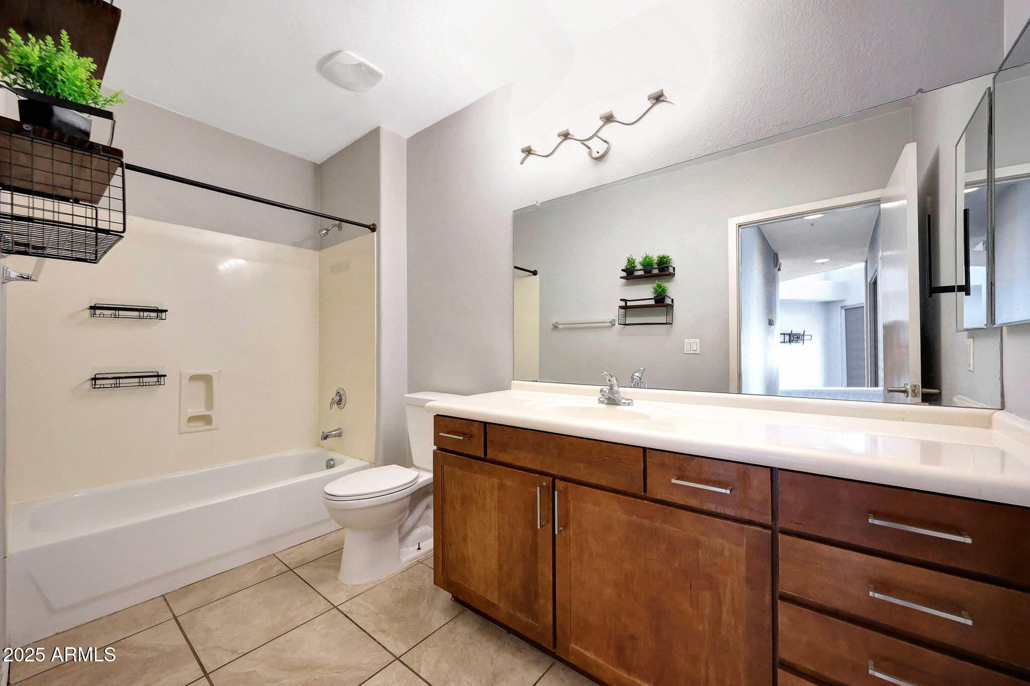 6605 North 93RD Avenue, Unit 1067 Glendale, AZ 85305 - Photo 27 of 47 a bathroom with a double vanity sink toilet mirror and bathtub