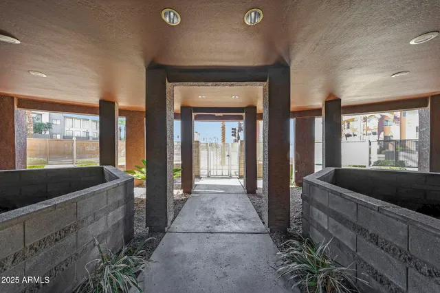 a view of a building with garden and sitting area