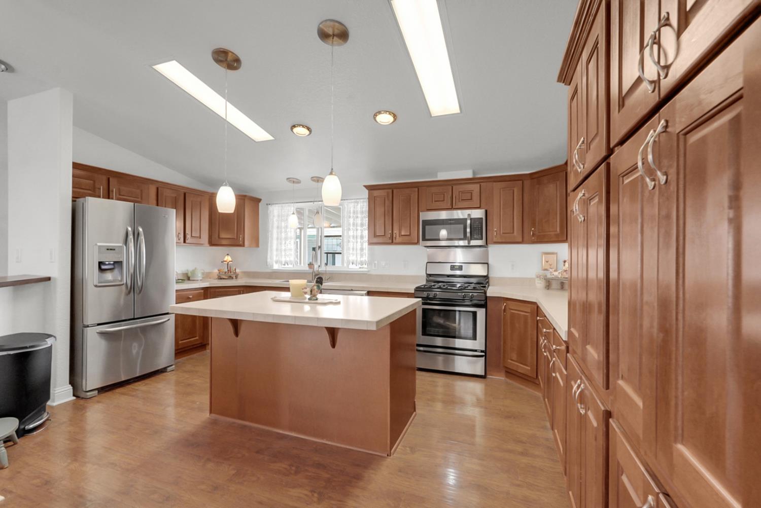 1459 Standiford, Unit 92 Modesto, CA 95350 - Photo 13 of 19 a kitchen with stainless steel appliances granite countertop a refrigerator oven a sink dishwasher and a refrigerator