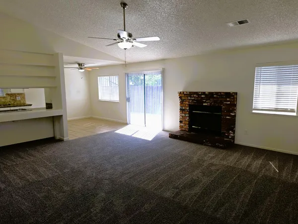 a living room with furniture and chandelier