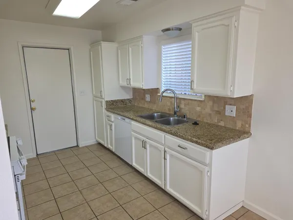 a kitchen with a sink and cabinets