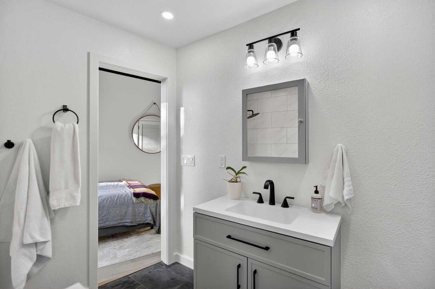 22080 Fiddletown Road Volcano, CA 95689 - Photo 33 of 94 a en suite bathroom with a toilet sink and mirror