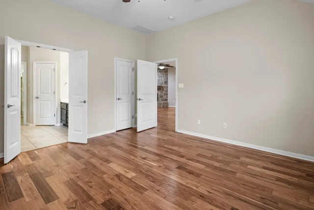 a view of an empty room and wooden floor