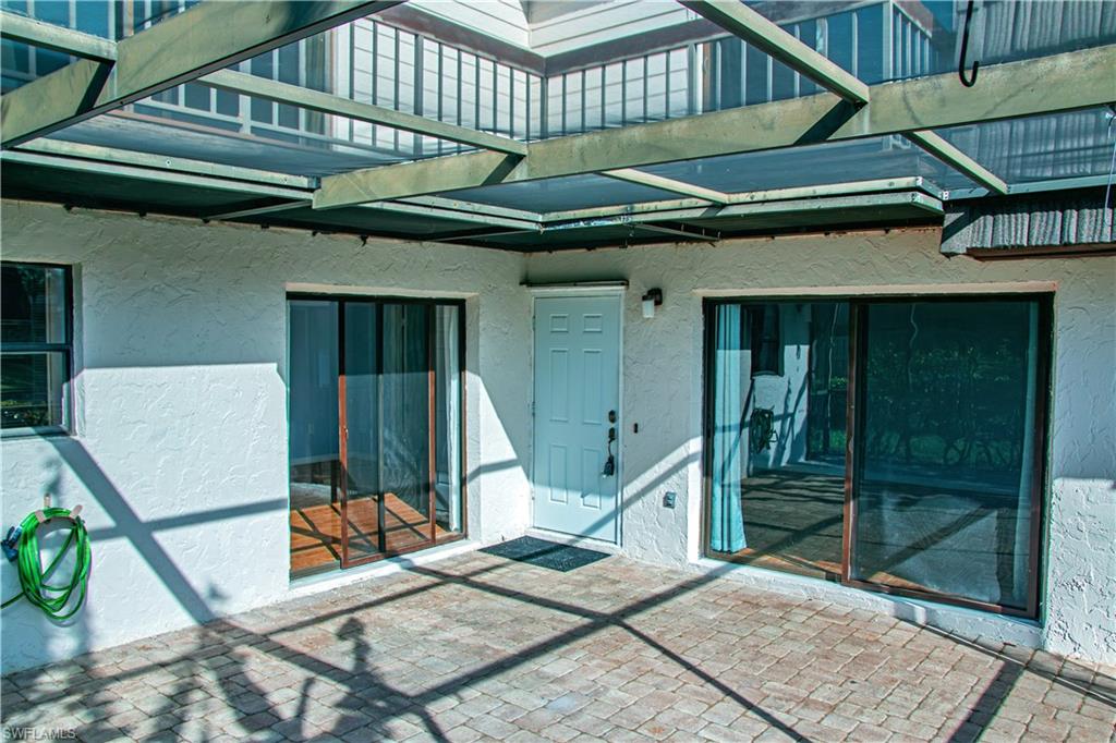 148 Lake Point Lane Naples, FL 34112 - Photo 6 of 17 a yellow building with a outdoor space