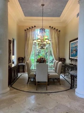 a dining room with furniture and a chandelier