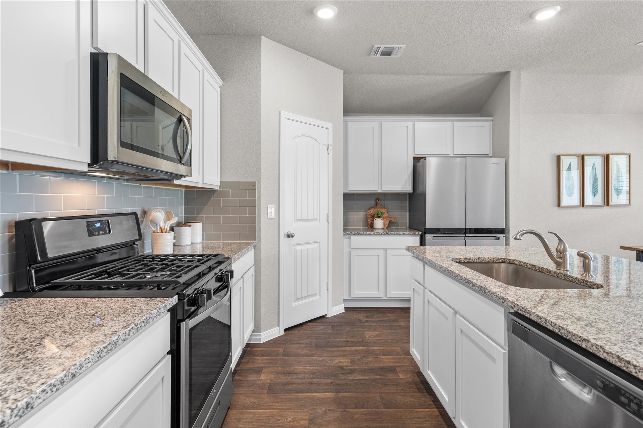 19525 Abigail Fillmore Road Manor, TX 78653 - Photo 9 of 38 Prepare meals with ease in this well-appointed kitchen, featuring a full suite of stainless steel appliances.