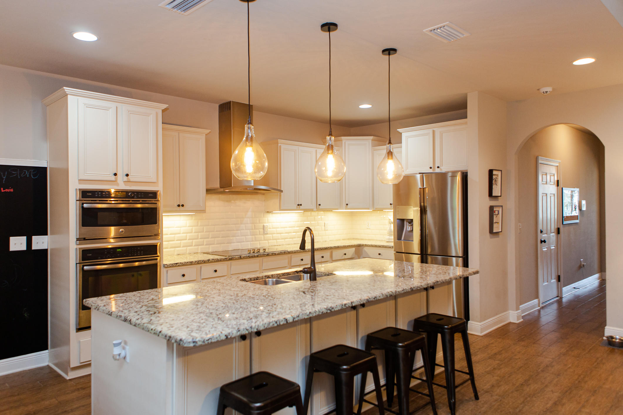 107 Maddox Street Santa Rosa Beach, FL 32459 - Photo 21 of 37 a kitchen with granite countertop a sink a center island and stainless steel appliances