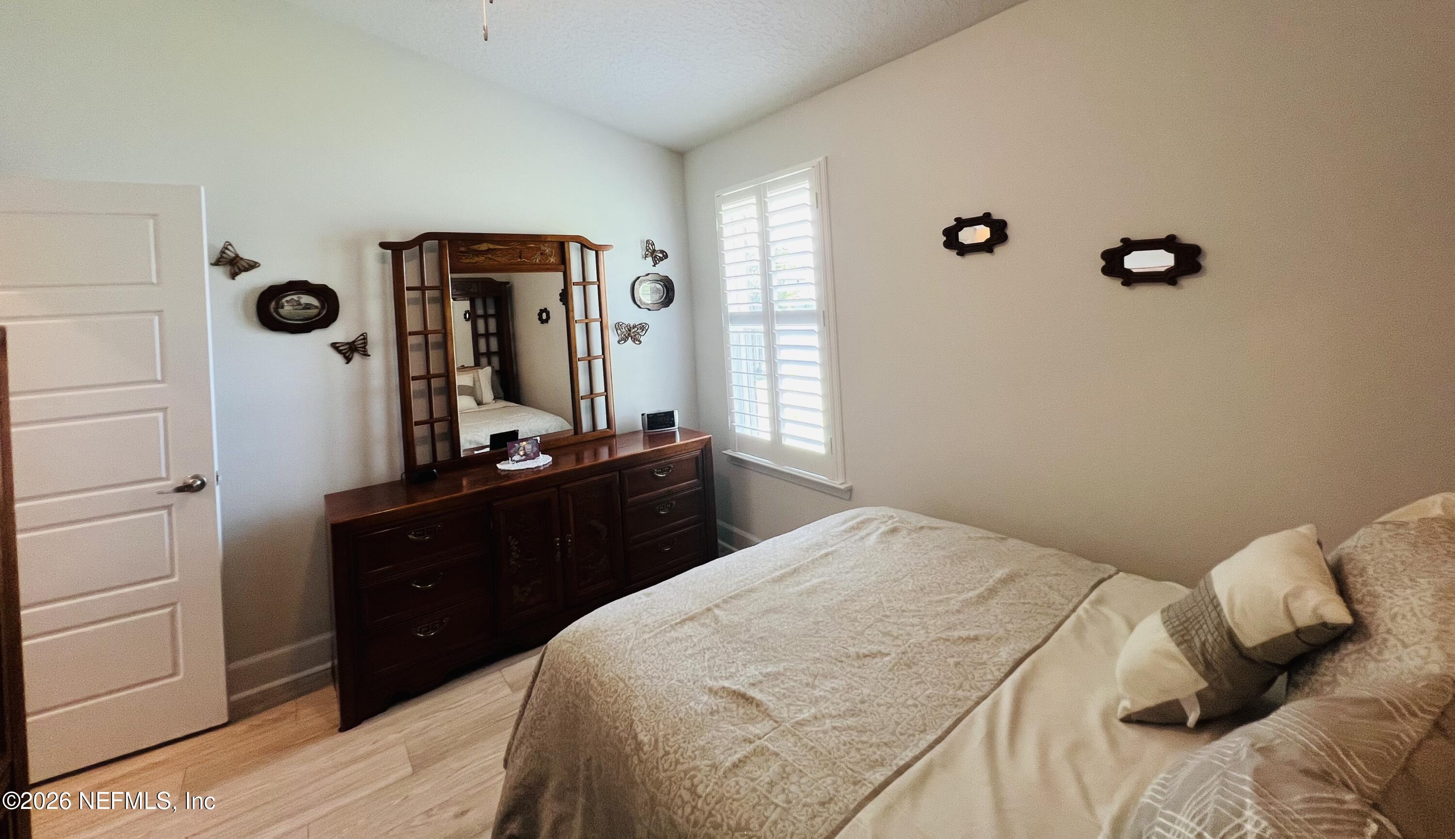 2 Rivertown Road Palm Coast, FL 32137 - Photo 63 of 80 a bedroom with a bed and a mirror
