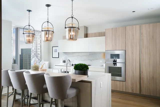 a kitchen with a table chairs and white cabinets