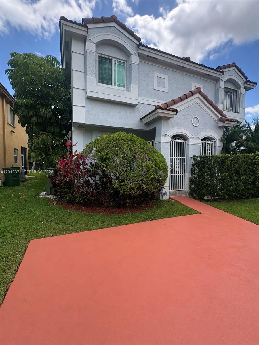 993 Northeast 3rd Avenue Homestead, FL 33030 - Photo 1 of 16 a front view of a house with a yard and garage