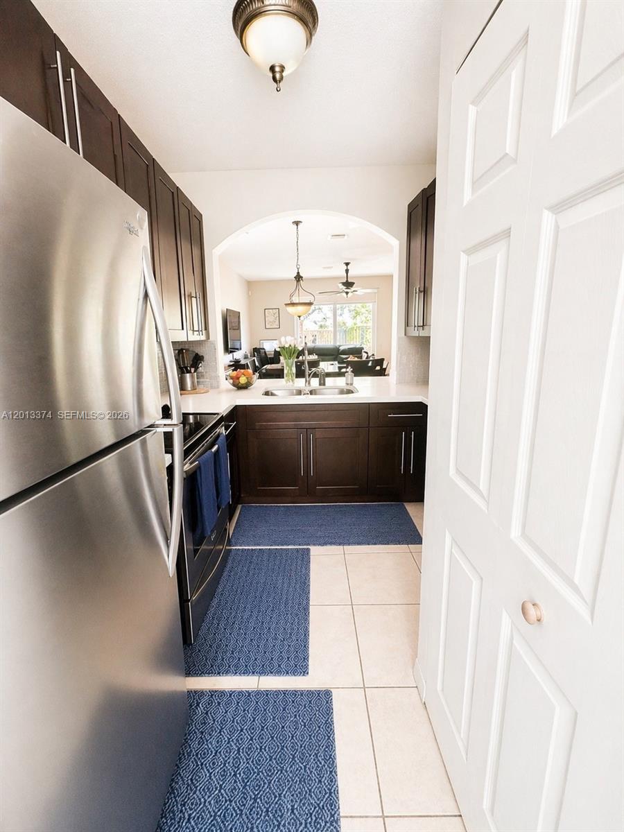 993 Northeast 3rd Avenue Homestead, FL 33030 - Photo 11 of 16 a kitchen with stainless steel appliances granite countertop a stove a refrigerator and a sink