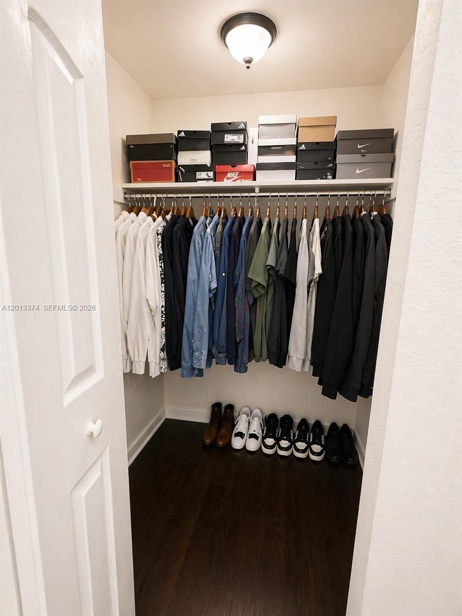 993 Northeast 3rd Avenue Homestead, FL 33030 - Photo 12 of 16 a view of walk in closet with clothes and shoes