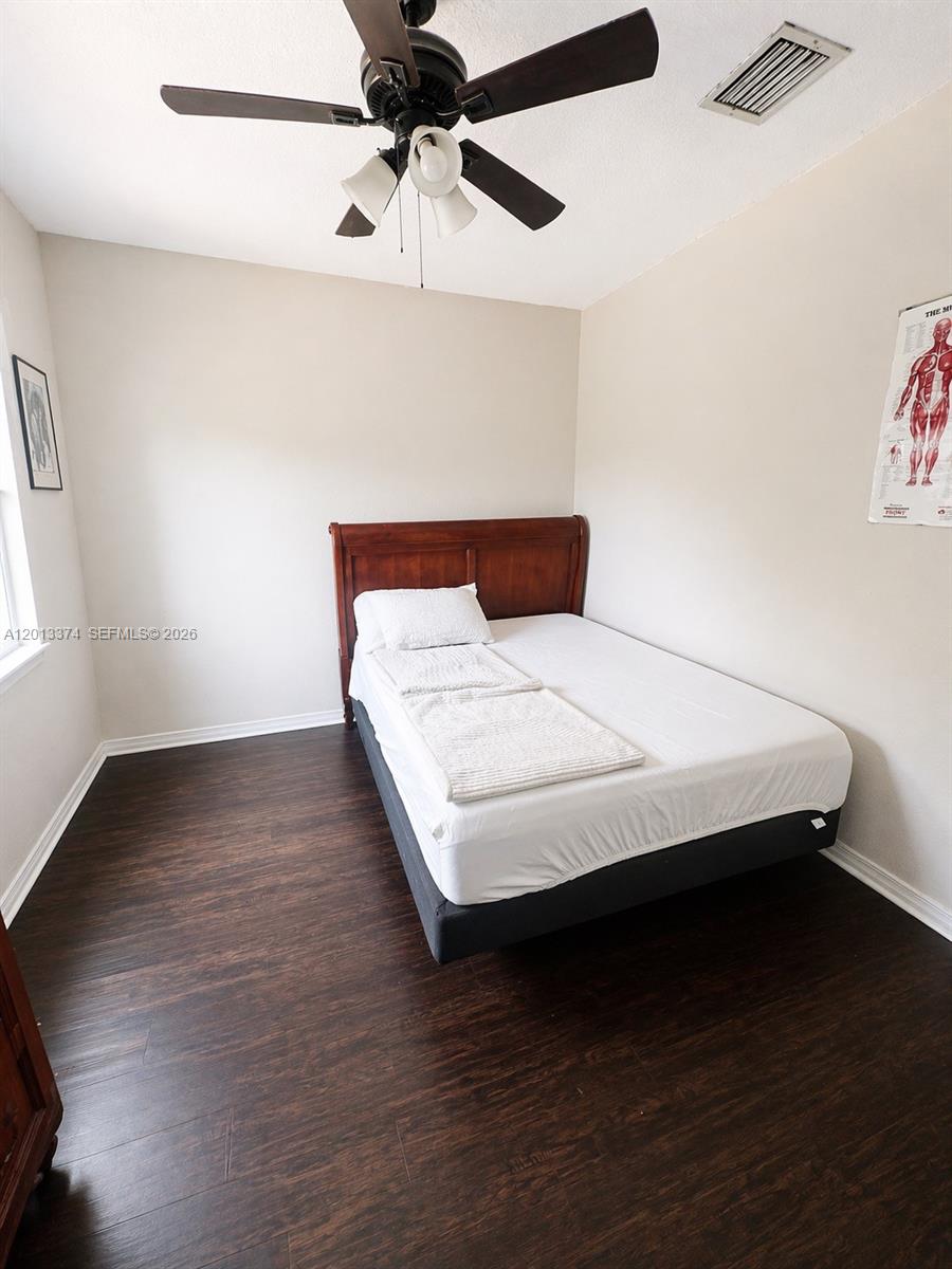 993 Northeast 3rd Avenue Homestead, FL 33030 - Photo 13 of 16 a bed sitting in a bedroom next to a window