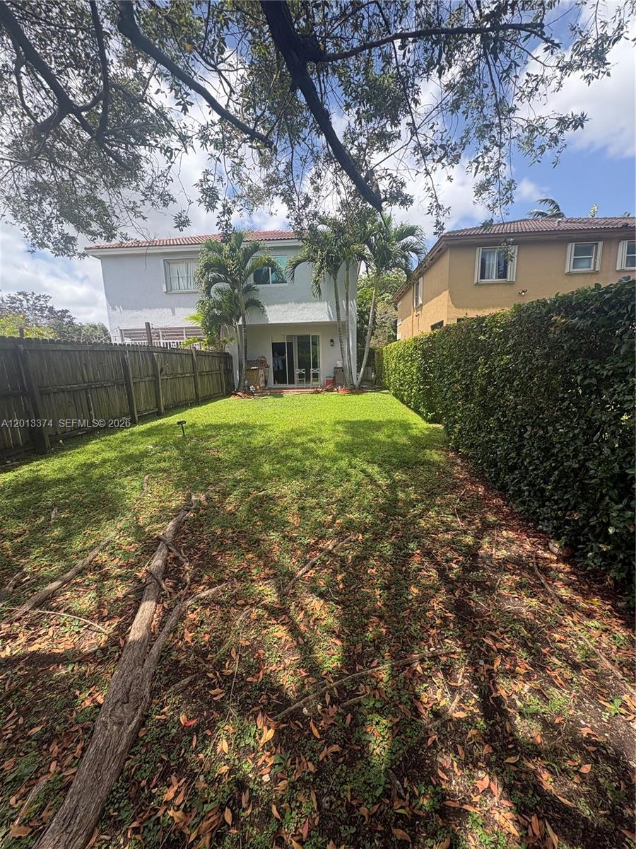 993 Northeast 3rd Avenue Homestead, FL 33030 - Photo 15 of 16 a front view of a house with a yard and trees