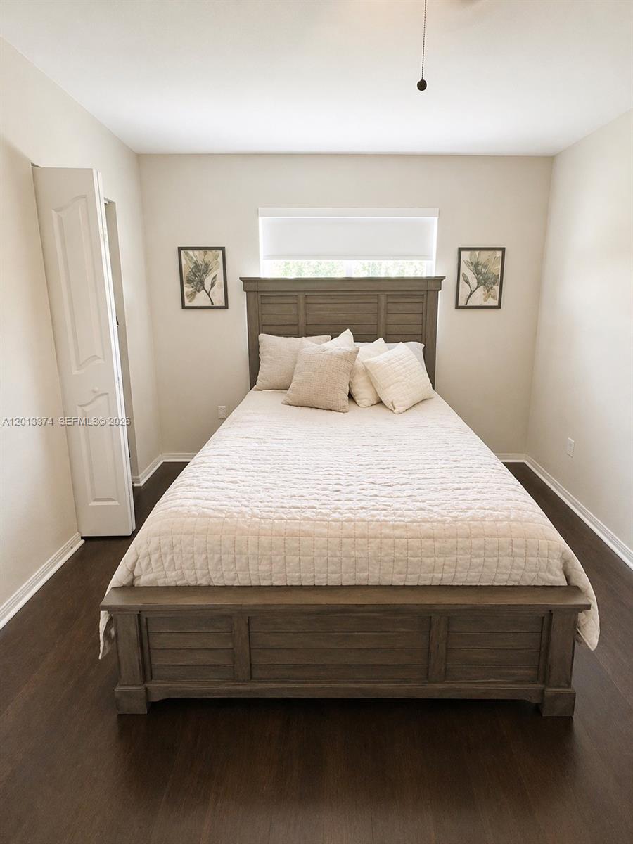 993 Northeast 3rd Avenue Homestead, FL 33030 - Photo 5 of 16 a large bed sitting in a bedroom next to a window