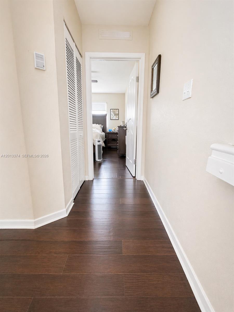 993 Northeast 3rd Avenue Homestead, FL 33030 - Photo 7 of 16 a view of a hallway with wooden floor and closet
