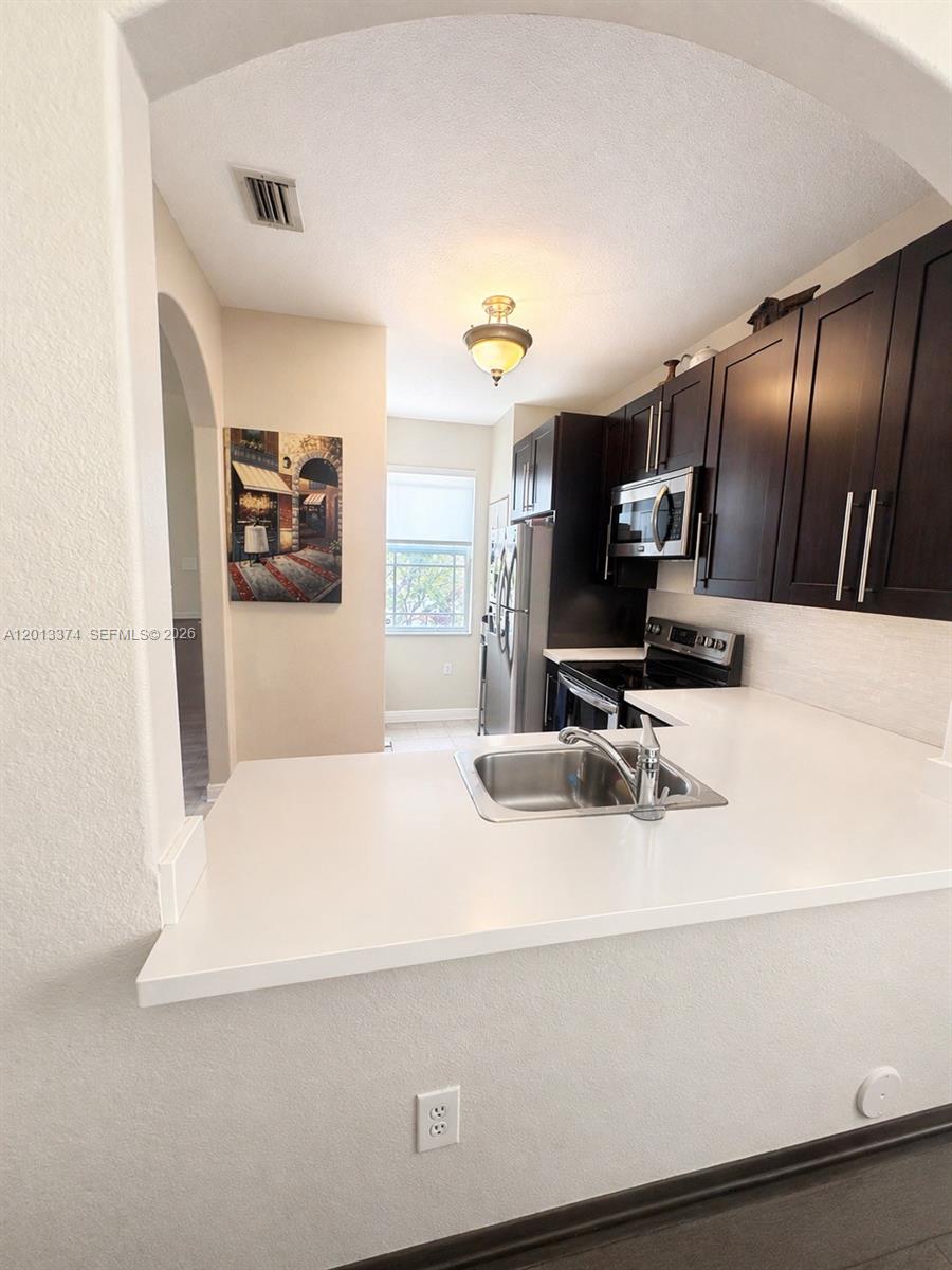 993 Northeast 3rd Avenue Homestead, FL 33030 - Photo 9 of 16 a bathroom with a sink and a mirror