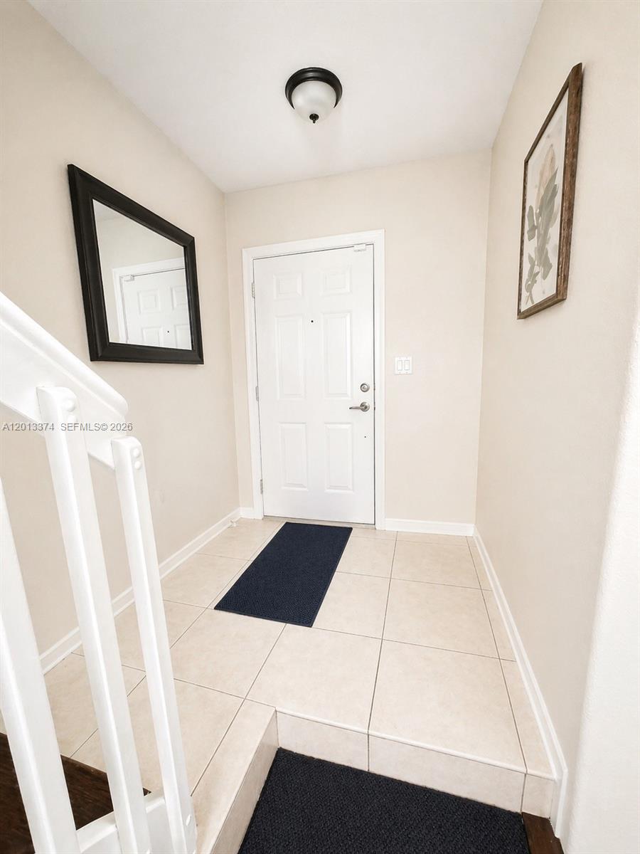993 Northeast 3rd Avenue Homestead, FL 33030 - Photo 10 of 16 a bedroom with a bed and a window