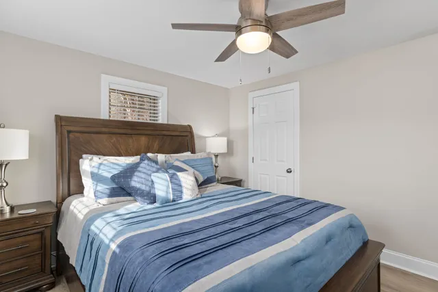 a bedroom with a large bed and a chandelier