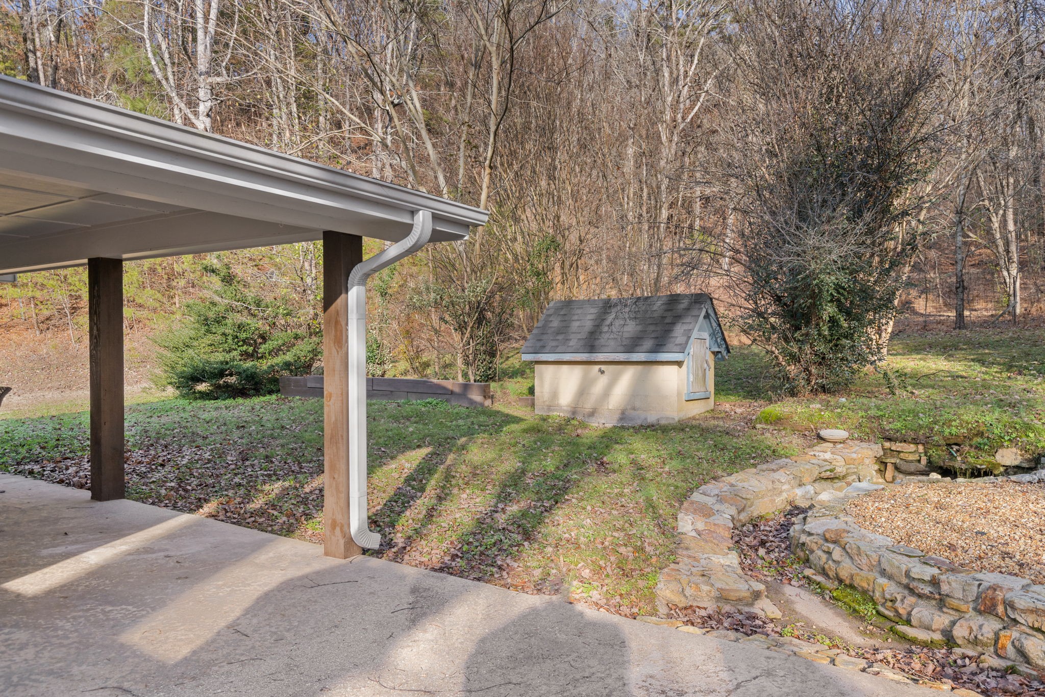 5685 County Road 14 Waterloo, AL 35677 - Photo 22 of 26 a backyard of a house with a fountain plants and large tree