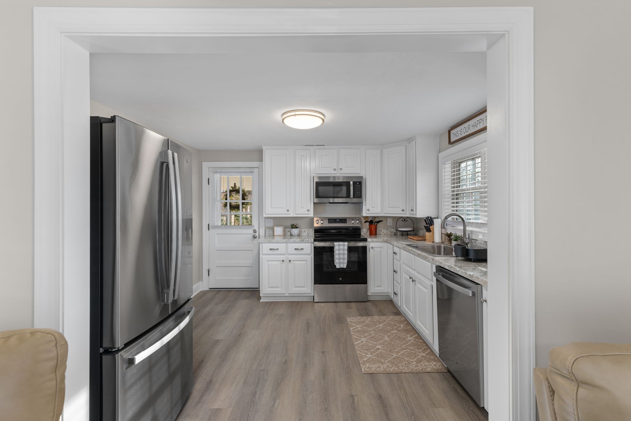 5685 County Road 14 Waterloo, AL 35677 - Photo 6 of 26 a kitchen with stainless steel appliances granite countertop a refrigerator oven a sink dishwasher and white cabinets with wooden floor