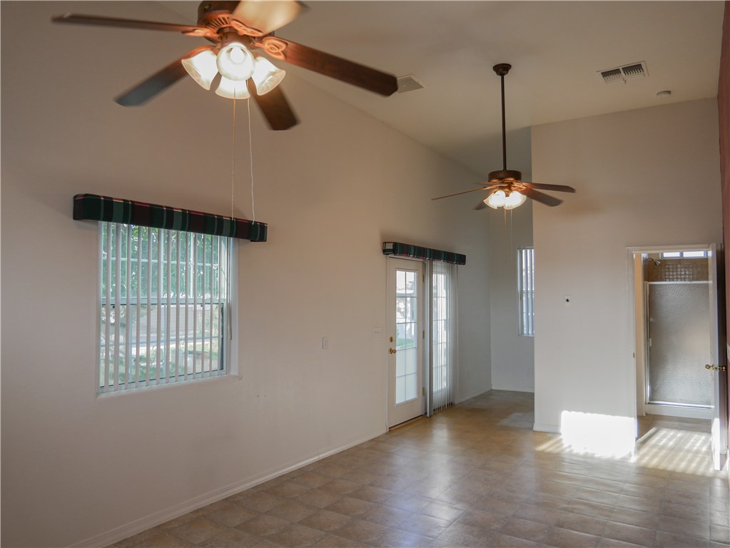 2575 Triangle S Street Kingman, AZ 86401 - Photo 40 of 45 a view of an empty room with a chandelier fan and a window