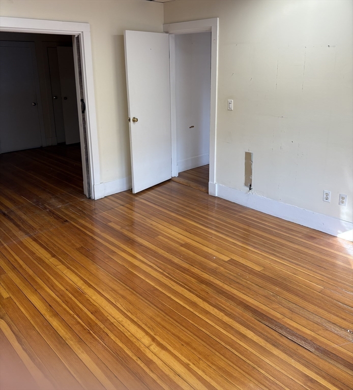 2020 Massachusetts Avenue, Unit 1 Cambridge, MA 02140 - Photo 6 of 11 a view of an empty room with wooden floor