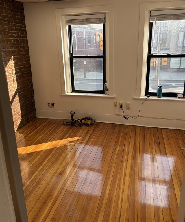 2020 Massachusetts Avenue, Unit 1 Cambridge, MA 02140 - Photo 7 of 11 a view of a room with wooden floor and a window