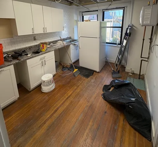 a kitchen with a sink appliances and cabinets