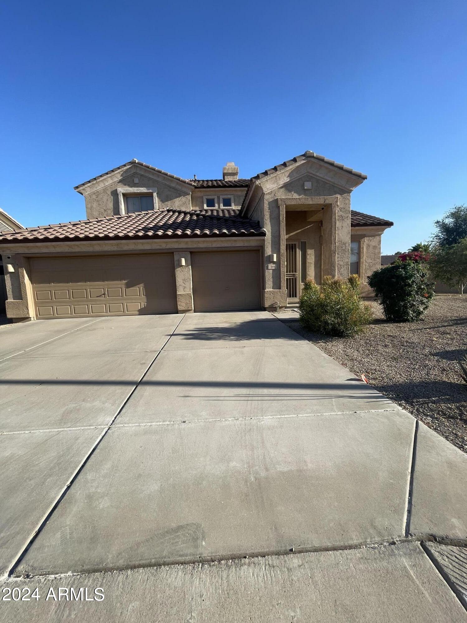 1433 West Longhorn Drive Chandler, AZ 85286 - Photo 1 of 27 a front view of a house with a garden