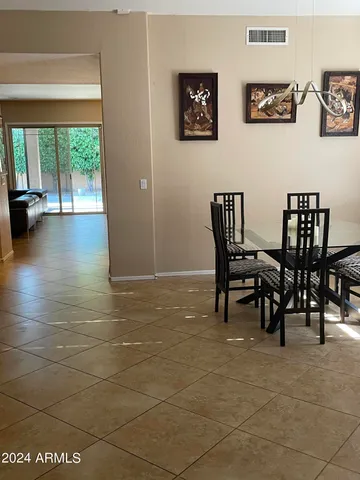 a view of a dining area with furniture and a large window