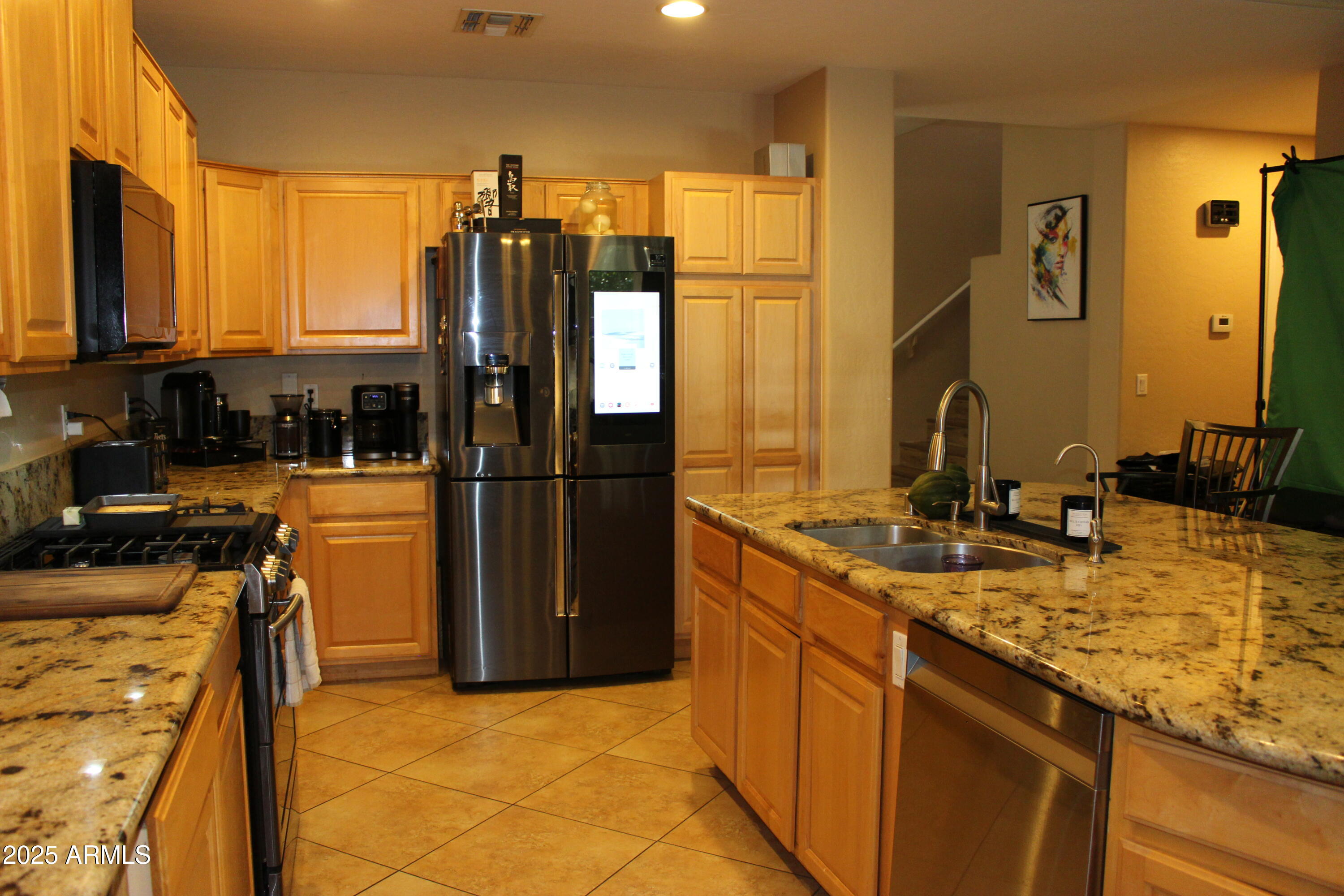 1433 West Longhorn Drive Chandler, AZ 85286 - Photo 9 of 27 a kitchen with stainless steel appliances granite countertop a sink stove and refrigerator