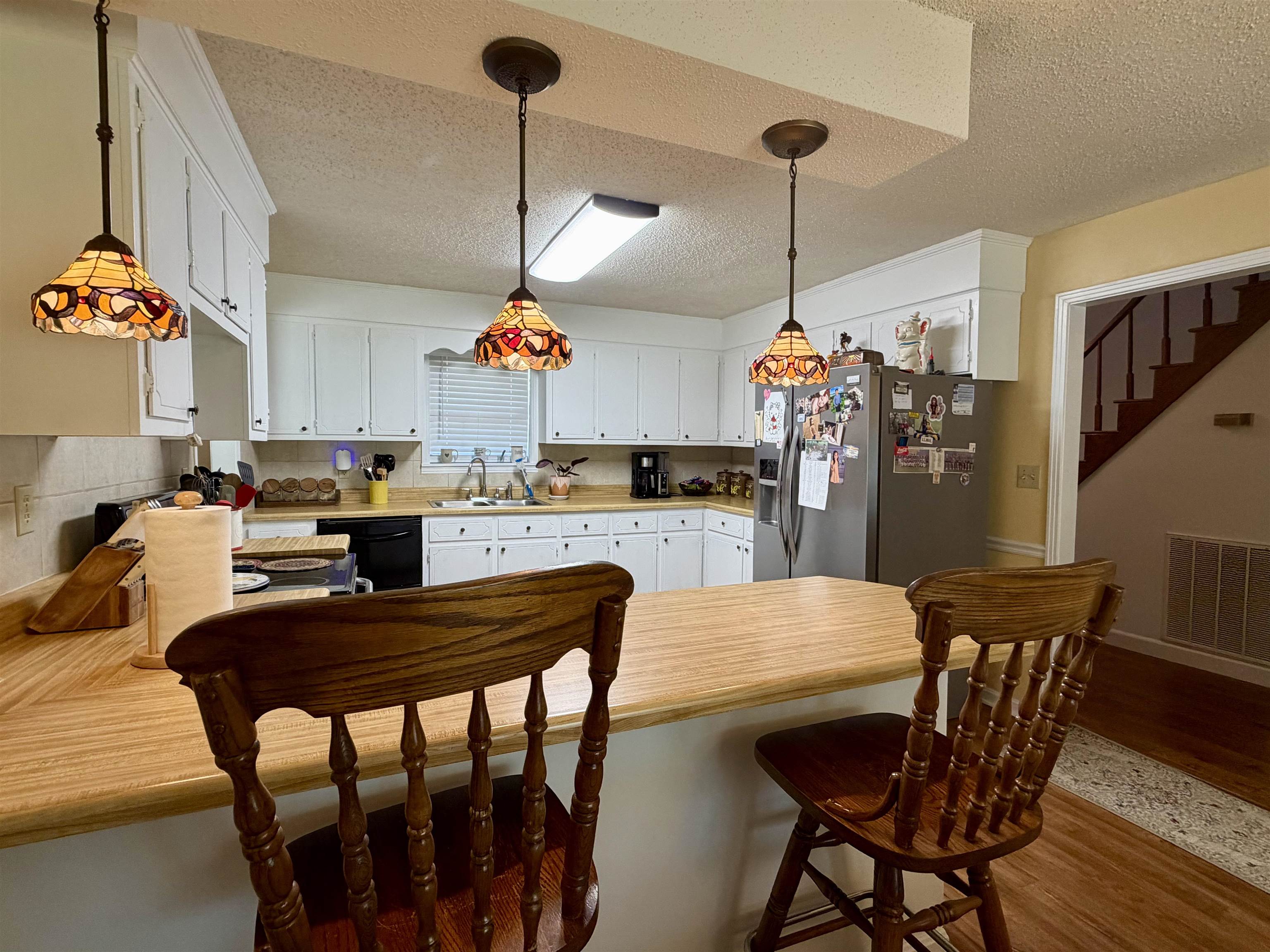 142 Treece Street Selmer, TN 38375 - Photo 9 of 36 Kitchen featuring white cabinetry and light wood-finish countertops