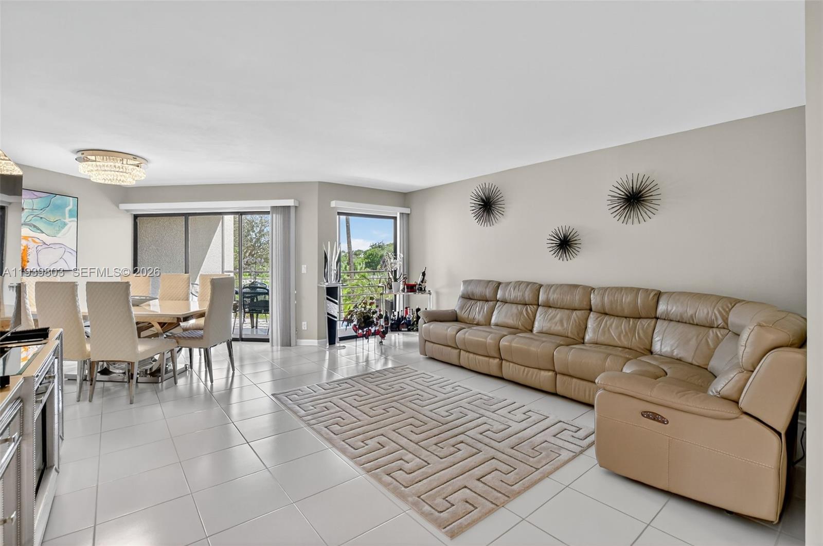 5901 Camino Del Sol, Unit 207 Boca Raton, FL 33433 - Photo 11 of 53 a living room with furniture and a large window