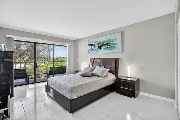 a bedroom with a bed and large window