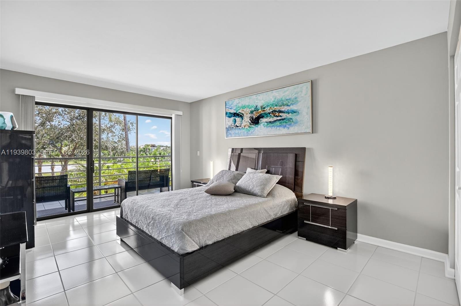 5901 Camino Del Sol, Unit 207 Boca Raton, FL 33433 - Photo 18 of 53 a bedroom with a bed and large window