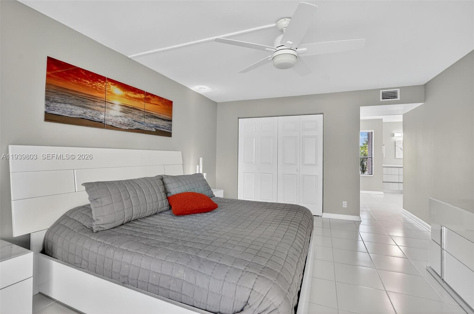 5901 Camino Del Sol, Unit 207 Boca Raton, FL 33433 - Photo 19 of 53 a bedroom with a large bed and a painting on the wall