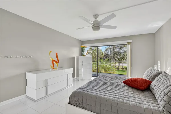 a bedroom with a bed and a large window
