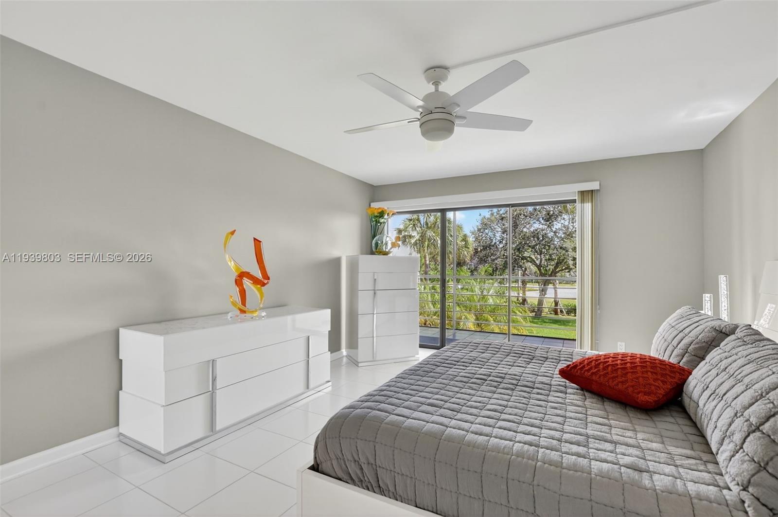 5901 Camino Del Sol, Unit 207 Boca Raton, FL 33433 - Photo 20 of 53 a bedroom with a bed and a large window
