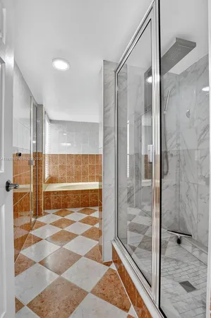 a bathroom with a glass shower door