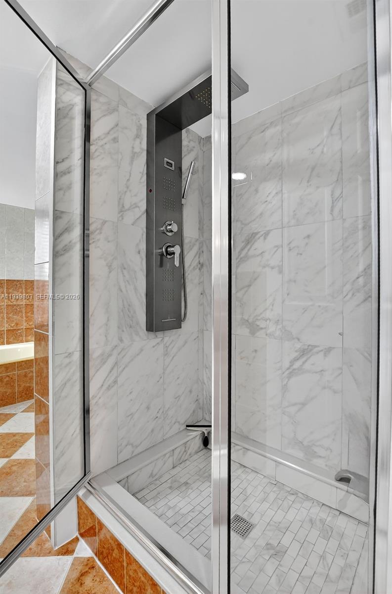 5901 Camino Del Sol, Unit 207 Boca Raton, FL 33433 - Photo 26 of 53 a bathroom with a shower and a glass door