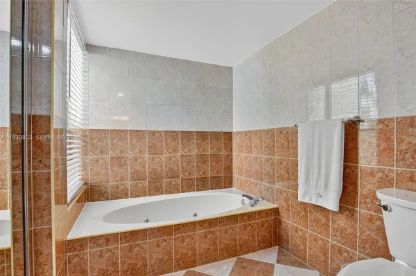 a bathroom with a bathtub and a shower