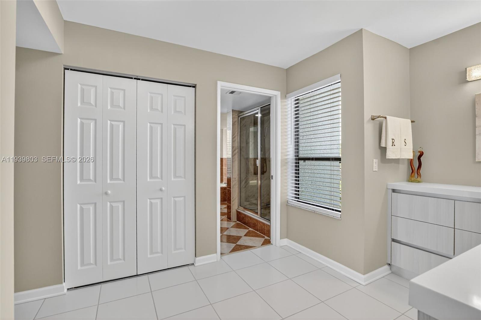 5901 Camino Del Sol, Unit 207 Boca Raton, FL 33433 - Photo 28 of 53 a view of an empty room with window and cabinet