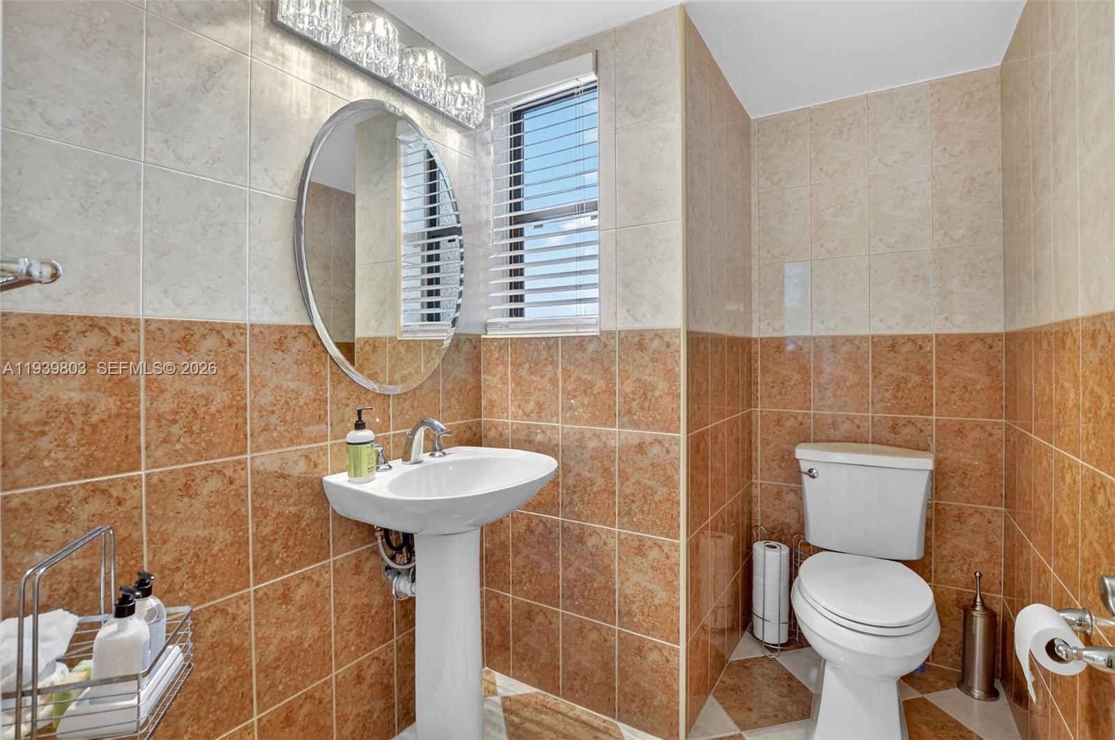 5901 Camino Del Sol, Unit 207 Boca Raton, FL 33433 - Photo 31 of 53 a bathroom with a sink toilet and a mirror