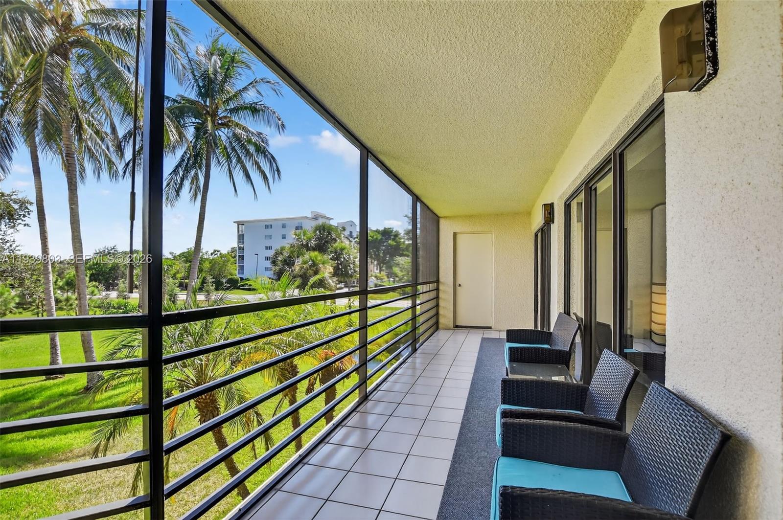 5901 Camino Del Sol, Unit 207 Boca Raton, FL 33433 - Photo 32 of 53 a view of a balcony with chairs